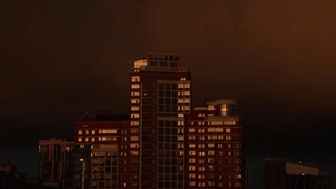 A city under an apocalyptic dramatic stormy red sky Stock Footage 337995989