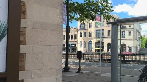 City view from behind bus stop shelter Stock Footage 323576833