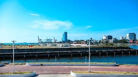 A city view with a large blue building in the background Stock Photos