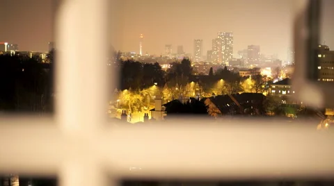 City view at night, camera tracking through a window. Stock Footage