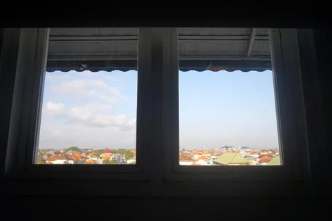 City view through window frame residential rooftops Stock Photos