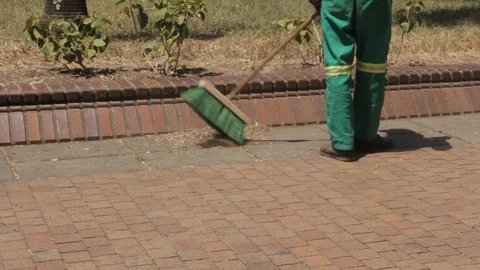 City worker sweeping the town square sidewalk downtown Stock Footage 88481350