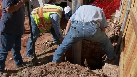 City workers digging down to a buried sewer line, 4K. Stock Footage 83420474
