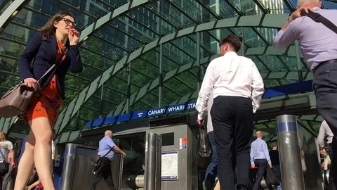 City workers walk in slow motion towards  Canary Wharf Underground Station 스톡 동영상 75969397