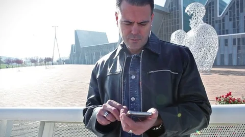 Cityscape and communication concept.Performing a search on smartphone Stock Footage 70725320