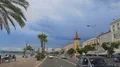 Cityscape, cars driving in resort town near ocean, tourists enjoying vacation 4k or 4k+ Resolution
