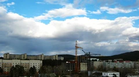 Cityscape with construction site and dramatic sky. Timelapse Видео 8604800