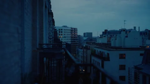 A cityscape with a dark blue sky and several tall buildings. Paris, France Stock Footage 327635086