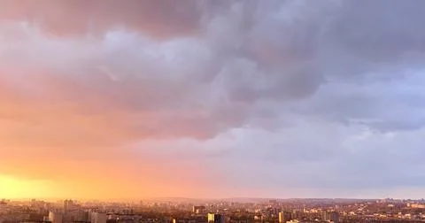 Cityscape at dramatic sunset with colorful clouds Photos