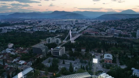 Cityscape featuring a stadium with green grass soccer field (football pitch) Stock Footage 211340817