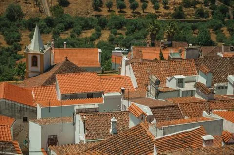 Cityscape with many rooftops, steeple and fields Stock Photos