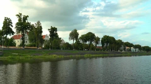 Cityscape by the river with buildings and trees in view during the day Stock Footage 340448007
