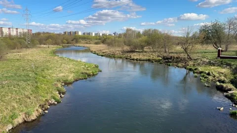 Cityscape with river, spring meadow, city buildings Stock Footage 333593350