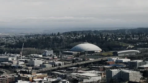 Cityscape with roads, buildings, and bridge under cloudy skies. Stock Footage 332721453