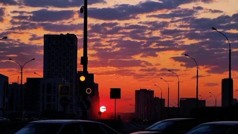 Cityscape Silhouette at Dramatic Sunset Urban Orange Sky with Traffic Stock Footage 329616100