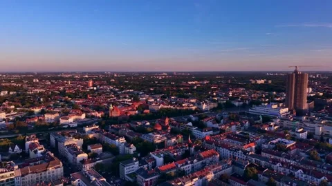 Cityscape at Solar Eclipse golden hour, setting sun. Great aerial view drone Stock Footage 344613693