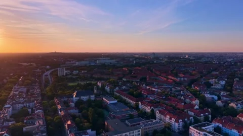 Cityscape at Solar Eclipse golden hour, setting sun. Lovely aerial view drone Stock Footage 344614919