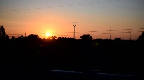 Cityscape with sun rusing behind transmission towers Stock Footage 67602348