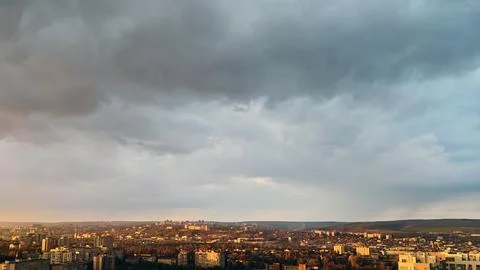 Cityscape at sunset under dramatic stormy sky Stock Photos