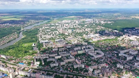 Cityscape under blue clouds. Beautiful view on the city surrounded by nature. Stock Footage 135880637