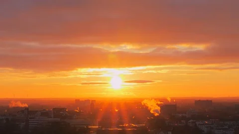 Cityscape view and beautiful cloudy sky at bright sunset Stock Footage 97345307