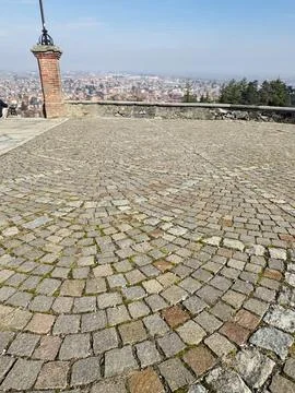 Cityscape View from Hill with Cobblestone Foreground. Stock Photos