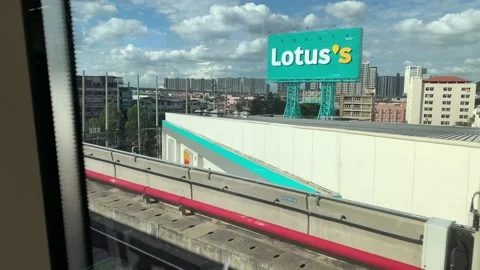 Cityscape view ride on train, passing huge sign. Beautiful city skyline Stock Footage 171147779