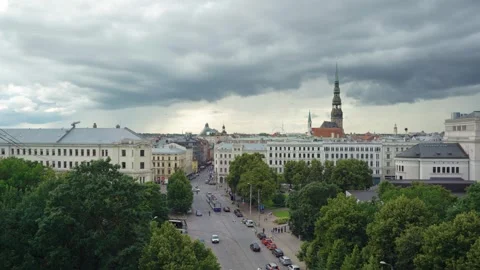Cityscape view of Riga Old Town with St. Peter Church spire, street tram, and Stock Footage 341851435