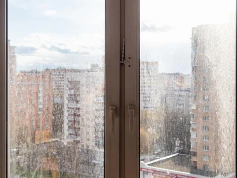 Cityscape view through dirty window glass at home Stock Photos