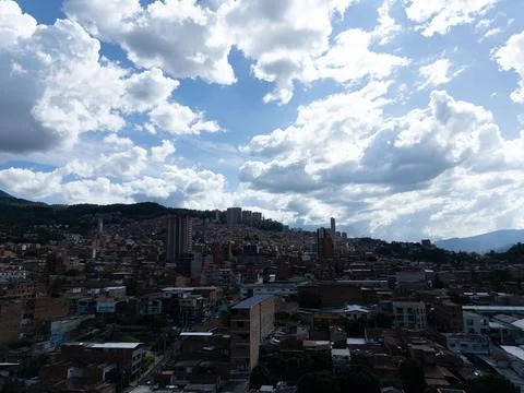 Cityscape view under a partly cloudy sky. Buildings and hills stretch to th.. Stock Photos
