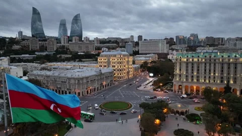 Cityscape View with Waving Flag at Dusk Stock Footage 341882643