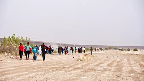 Ciudad Juarez, Mexico - 04/30/2024: Thousands Walk Across Border Wall Stock Footage 276720111