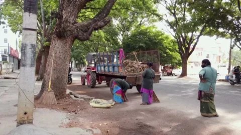 Civic workers seen clearing the street garbage after sweeping in Mysore, India. Stock Footage 154257546