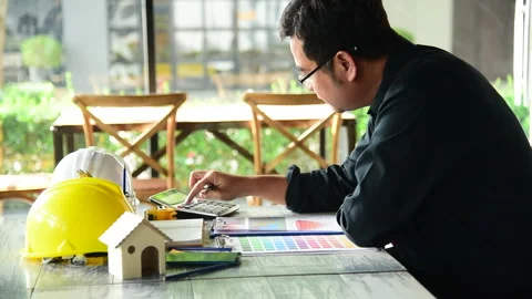 Civil construction engineer working with laptop at desk office with white yellow Stock Footage 248417109