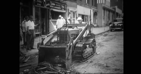 Civil defence worker cleaning debris from road with bulldozer Stock Footage
