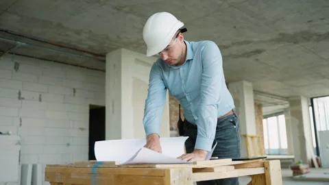 Civil engineer analyzing construction blueprints at building site Stock Footage 285674321