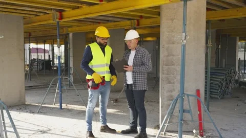 Civil engineer and architect discussing building plan Stock Footage 343449295