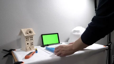 Civil engineer architech writing reading blueprints and looking at scale model Stock Footage 258423266