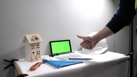 Civil engineer architech writing reading blueprints and looking at scale model Stock Footage 258423315