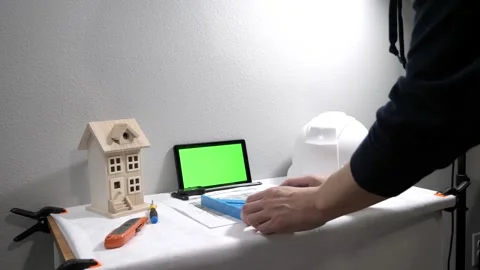 Civil engineer architech writing reading blueprints and looking at scale model Видео 258423324