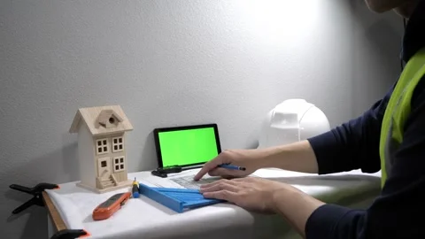 Civil engineer architech writing reading blueprints and looking at scale model Vidéo 258423402