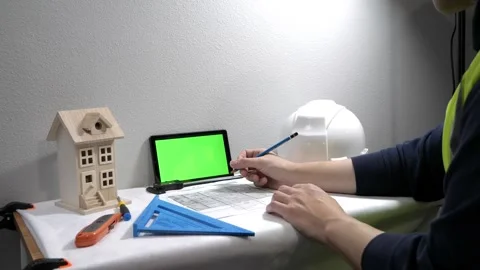 Civil engineer architech writing reading blueprints and looking at scale model Vidéo 258423451