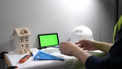 Civil engineer architech writing reading blueprints and looking at scale model Vidéo 258423454