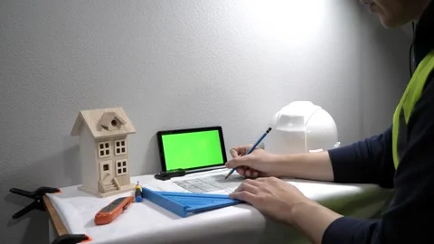 Civil engineer architech writing reading blueprints and looking at scale model Vidéo 258423455