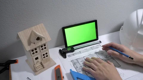 Civil engineer architech writing reading blueprints and looking at scale model Vidéo 258423517