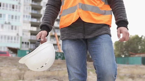 Civil engineer is on a construction site, in the hand has a white helmet Stock Footage 117989396