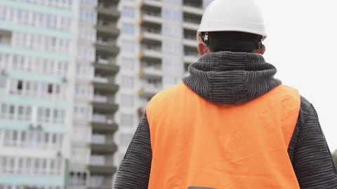 Civil engineer is on a construction site wearing a white helmet Stock Footage 117989371