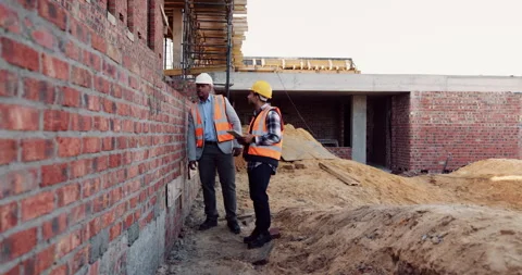 Civil engineer, discussion and men with tablet at construction site, teamwork Stock Footage 336222674