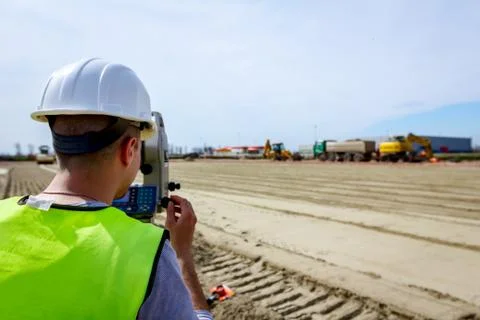 Civil engineer, geodesist is working with total station on a building site Fotos de archivo