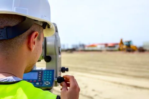 Civil engineer, geodesist is working with total station on a building site Fotos de archivo